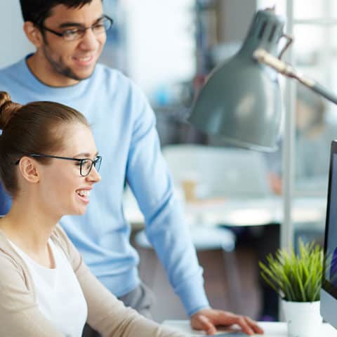 Two workers at a computer